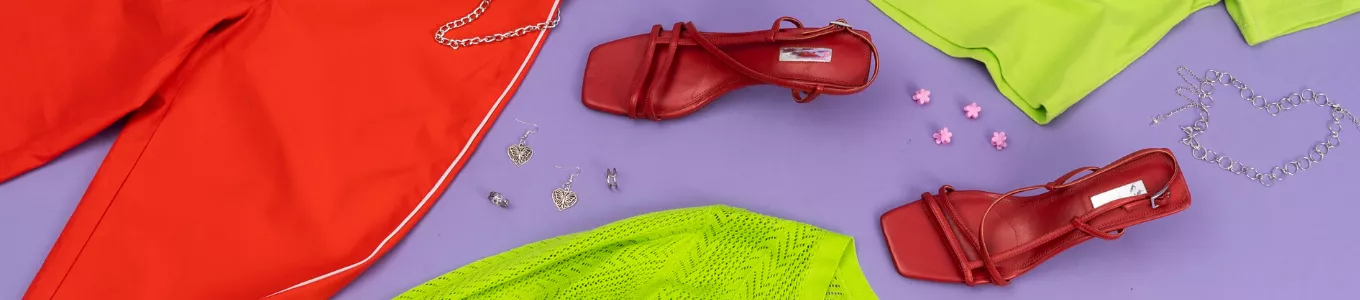 colorful flatlay with clothing, jewelry, and shoes