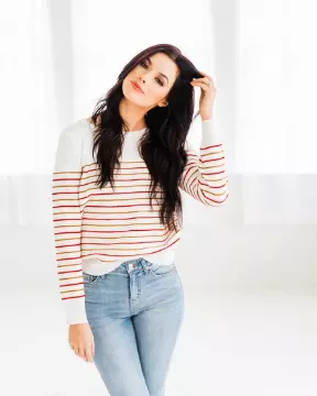 woman modeling sweater and jeans